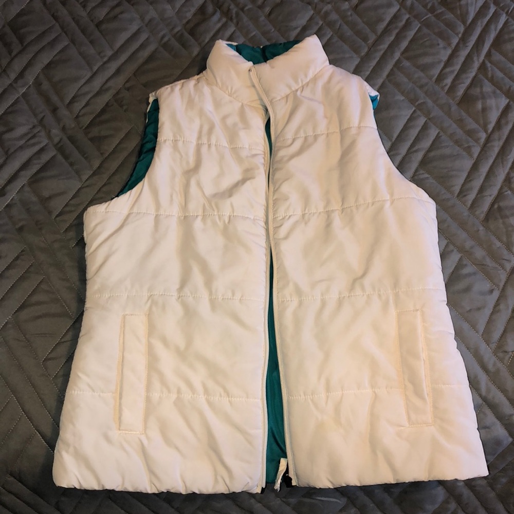 Reversible teal and white vest.